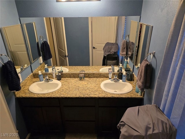 bathroom with a sink and double vanity