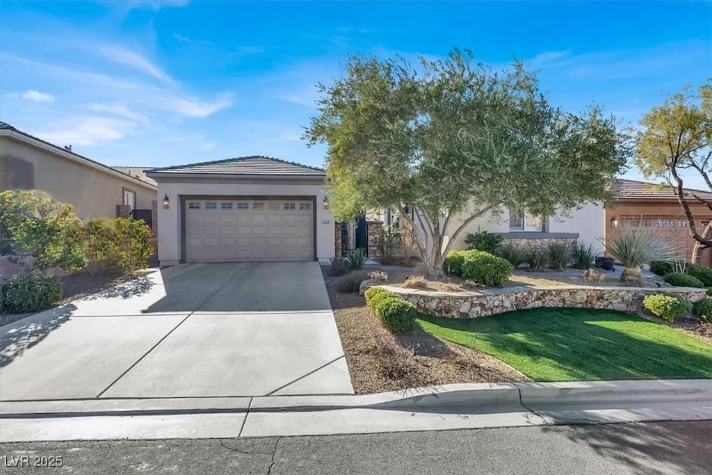 view of front of house featuring a garage and a front lawn