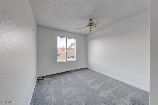 empty room with ceiling fan, carpet floors, and a textured ceiling