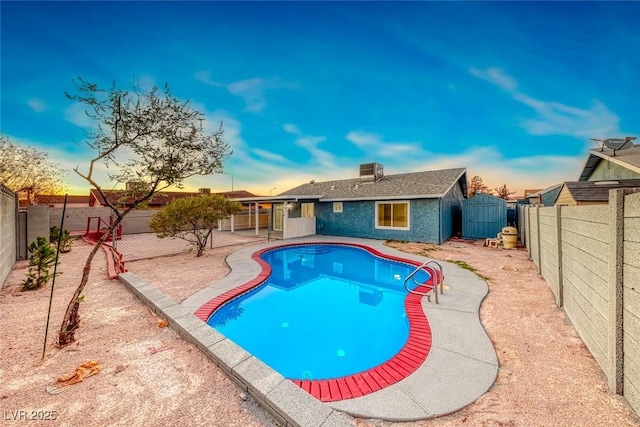 pool at dusk featuring a patio area and a shed