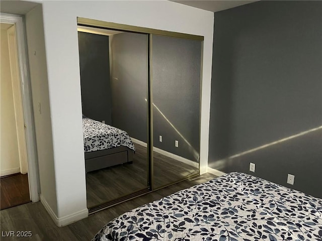 bedroom featuring dark hardwood / wood-style floors and a closet