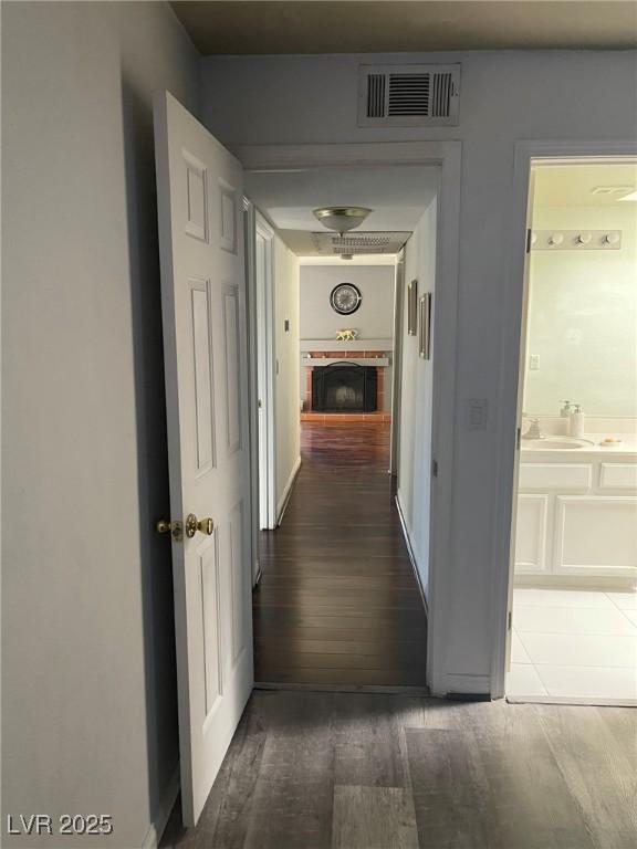 corridor featuring sink and dark wood-type flooring