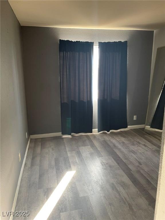 spare room with wood-type flooring