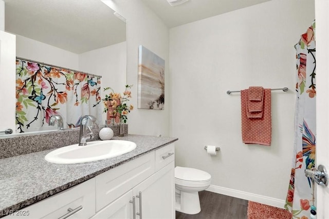 bathroom featuring hardwood / wood-style floors, toilet, and vanity