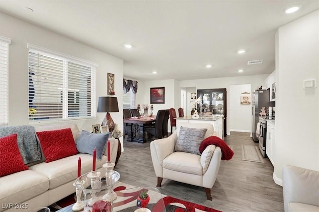 living room featuring plenty of natural light and dark hardwood / wood-style flooring