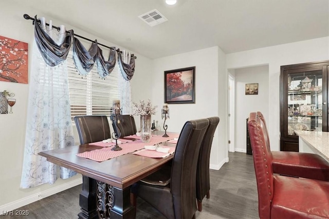 dining space featuring dark hardwood / wood-style flooring