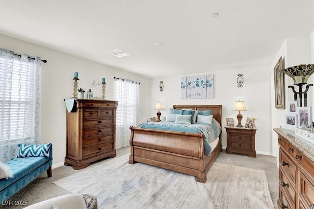 carpeted bedroom with multiple windows