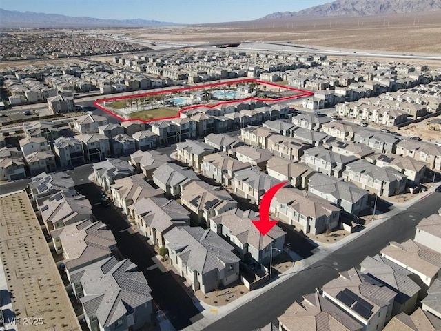 birds eye view of property with a mountain view