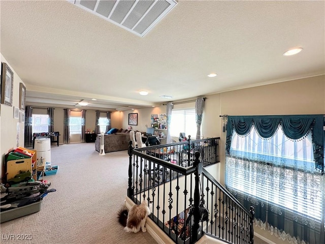 stairway with carpet flooring and a textured ceiling