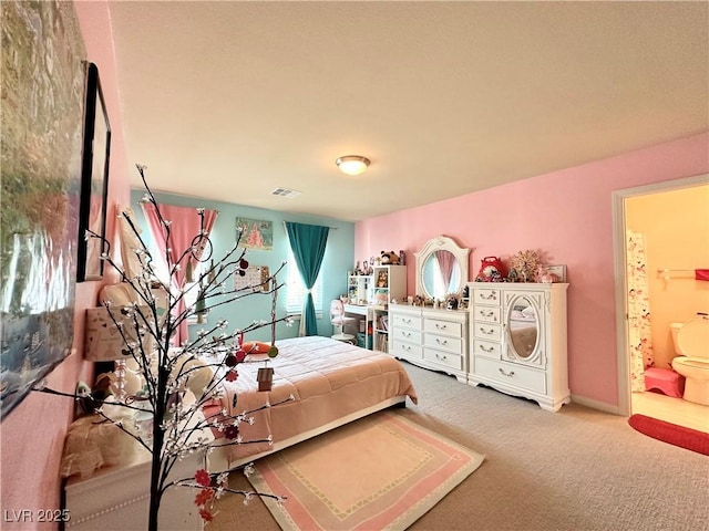 carpeted bedroom featuring ensuite bath