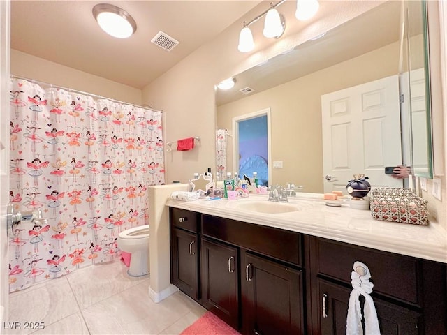 bathroom with tile patterned flooring, vanity, toilet, and walk in shower