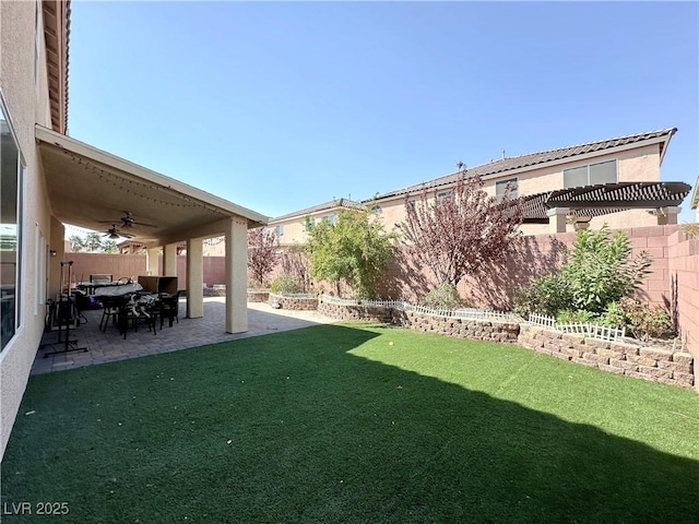 view of yard with a patio and ceiling fan