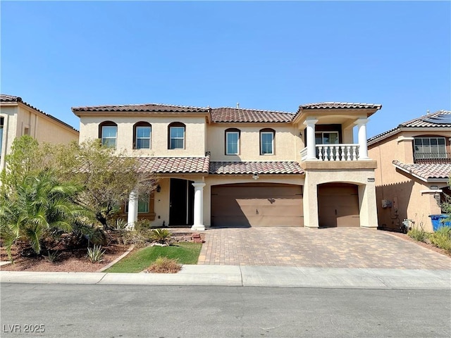 mediterranean / spanish home featuring a balcony and a garage