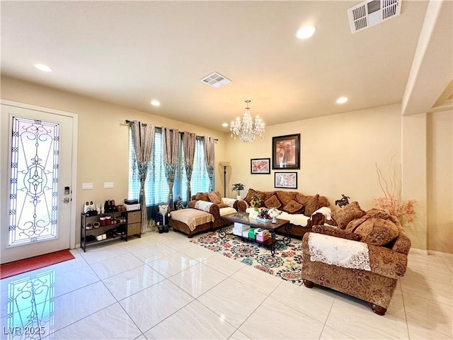 tiled living room featuring a chandelier and a wealth of natural light