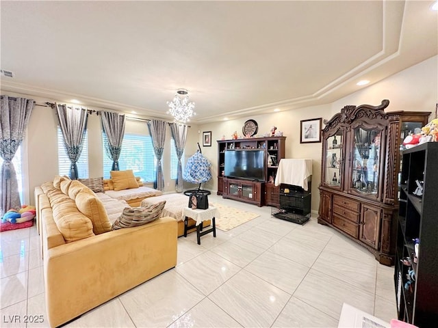 living room featuring a tray ceiling, light tile patterned flooring, and a notable chandelier