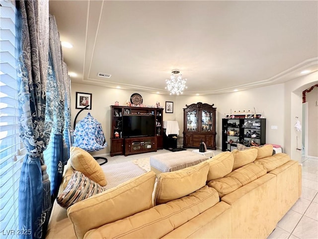 tiled living room featuring plenty of natural light and a notable chandelier