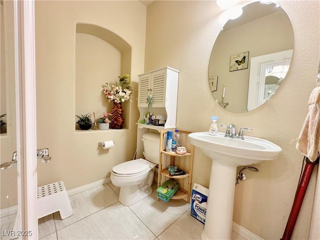 bathroom with sink, tile patterned flooring, and toilet