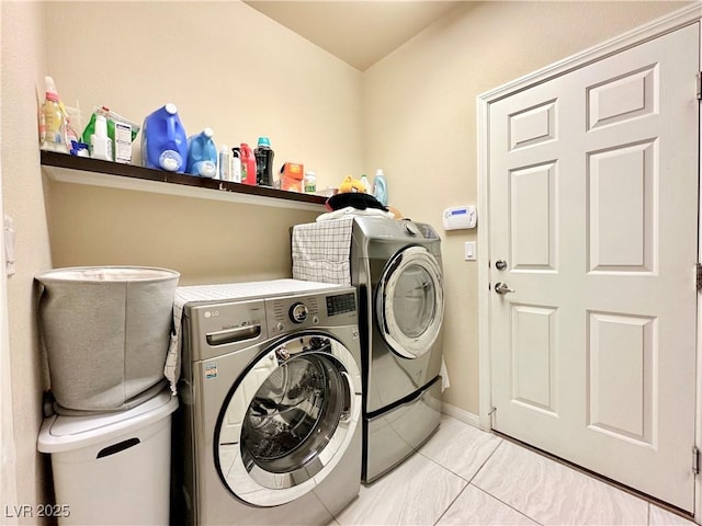 clothes washing area with washer and clothes dryer