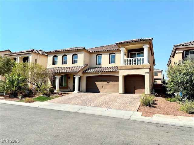 mediterranean / spanish-style home with a balcony and a garage