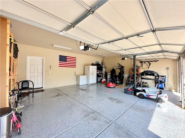 garage featuring a garage door opener and white fridge with ice dispenser