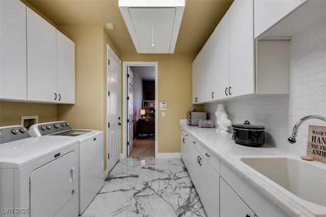 washroom with washer and clothes dryer, sink, and cabinets