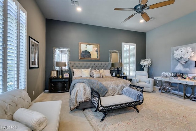 bedroom featuring ceiling fan and light carpet