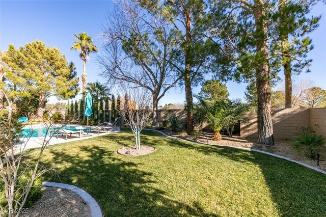 view of yard featuring a fenced in pool