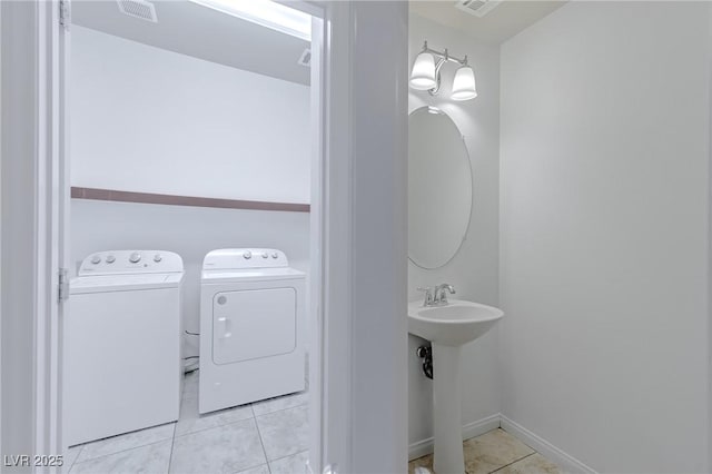 bathroom with sink, tile patterned floors, and separate washer and dryer