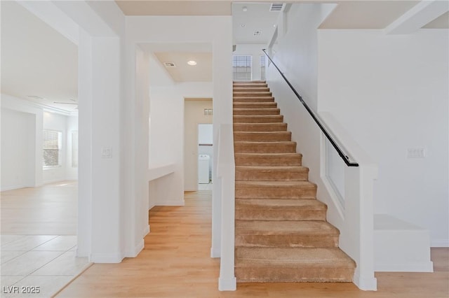 stairs with hardwood / wood-style flooring