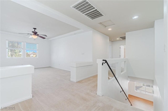 unfurnished room featuring ceiling fan and light carpet