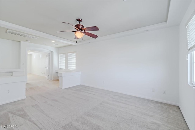 carpeted spare room with ceiling fan