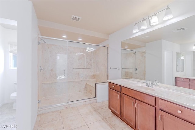 bathroom with vanity, toilet, tile patterned flooring, and walk in shower