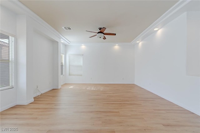 unfurnished room with ceiling fan, light wood-type flooring, plenty of natural light, and crown molding