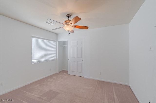 empty room featuring light carpet and ceiling fan