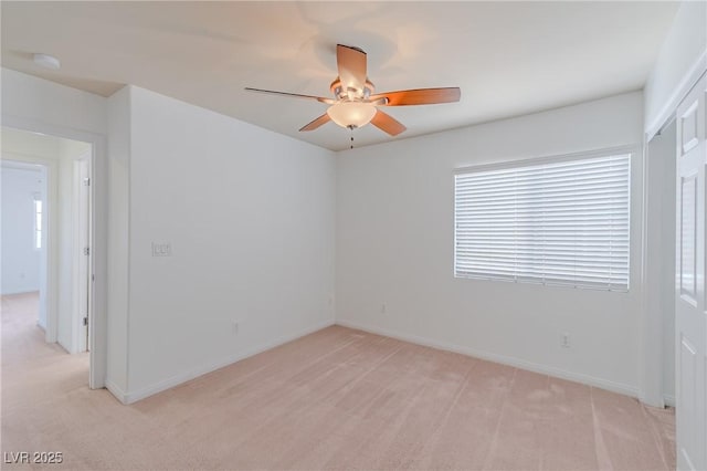 carpeted spare room with ceiling fan