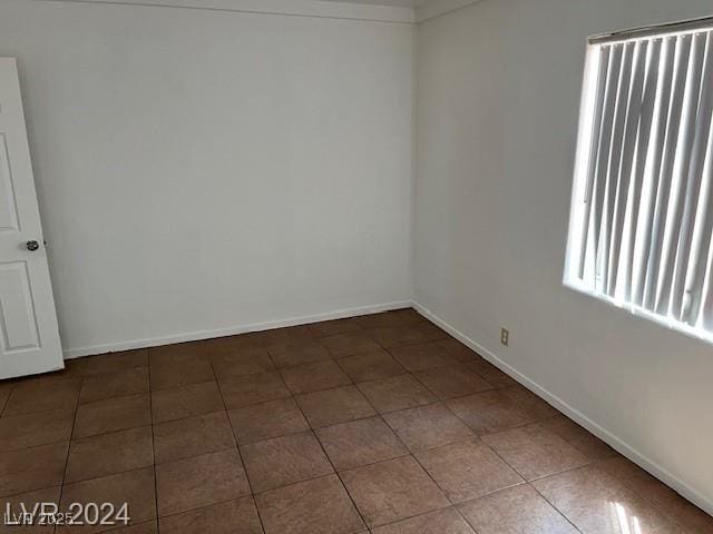 unfurnished room with tile patterned floors