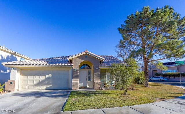 view of front of house featuring a garage and a front lawn