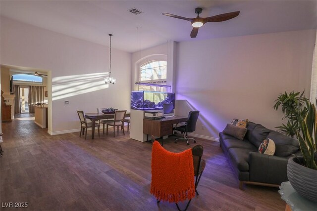 office space with dark hardwood / wood-style flooring and ceiling fan with notable chandelier