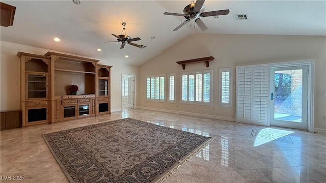 unfurnished living room with ceiling fan and high vaulted ceiling