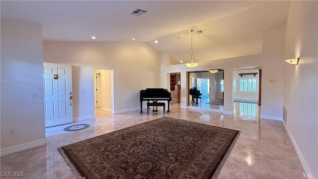 entryway featuring high vaulted ceiling