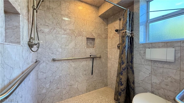 bathroom with a shower with curtain and toilet