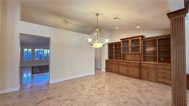 interior space with vaulted ceiling and an inviting chandelier