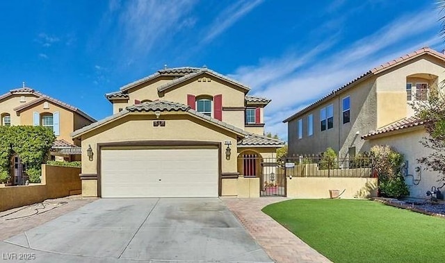 mediterranean / spanish house featuring a front yard and a garage