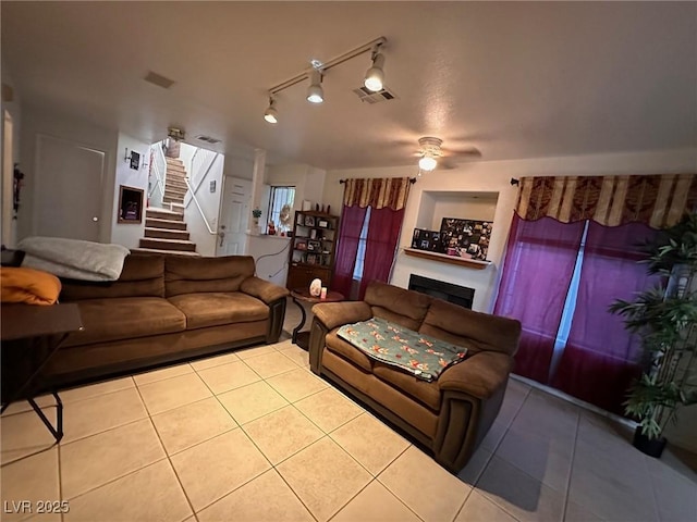 tiled living room with ceiling fan