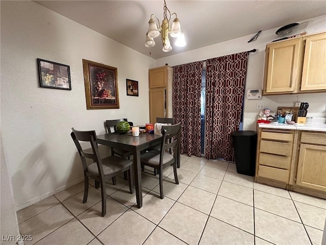 dining area featuring light tile patterned floors and an inviting chandelier