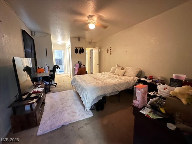 bedroom featuring carpet, ceiling fan, and a textured ceiling