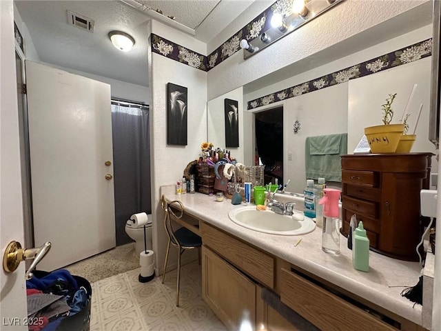 bathroom featuring vanity and a textured ceiling