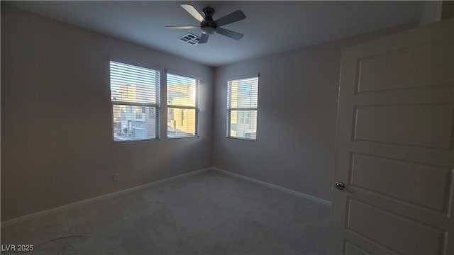 spare room featuring ceiling fan and carpet