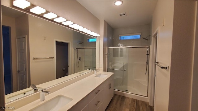 bathroom with vanity, hardwood / wood-style flooring, toilet, and a shower with shower door