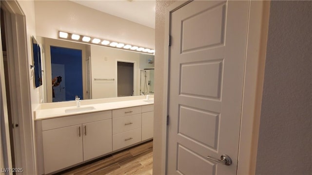 bathroom with hardwood / wood-style flooring and vanity